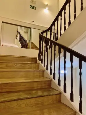 a staircase in a house with wood floors at Hotel Porto Rico in Porto