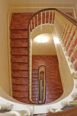 a spiral staircase in a house with wooden floors at Santa Clara Porto in Porto
