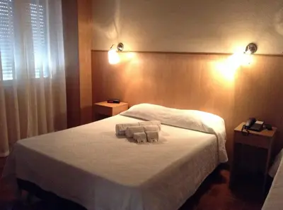a bedroom with a bed with two towels on it at Santa Clara Porto in Porto