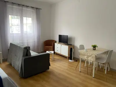 a living room with a couch and a table with a television at Guest house D. Filipe I in Porto