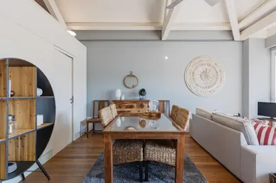 a living room with a table and a couch at Oporto LightHouse Apartment by DA'HOME in Porto
