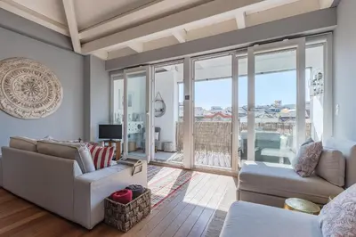 a living room with a couch and a table at Oporto LightHouse Apartment by DA'HOME in Porto