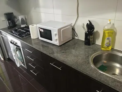 a microwave sitting on a counter next to a sink at Porta do Sol in Porto