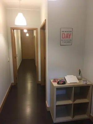 a hallway with a desk and a day sign on the wall at Porta do Sol in Porto