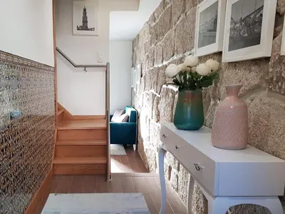 a room with a table with a vase on it at 22 Oporto Guesthouse in Porto