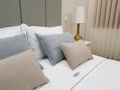 a white bed with pillows on top of it at 22 Oporto Guesthouse in Porto