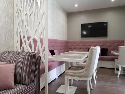 a dining room with a white table and chairs at 22 Oporto Guesthouse in Porto