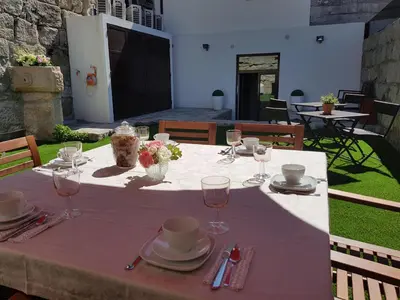 a table with a white table cloth and glasses on it at 22 Oporto Guesthouse in Porto