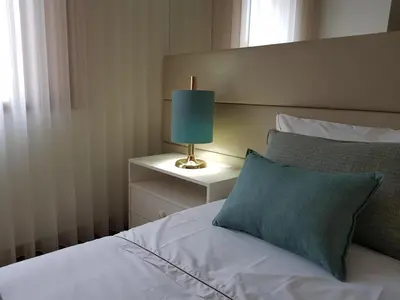 a bedroom with a bed with a blue pillow and a lamp at 22 Oporto Guesthouse in Porto