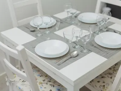 a white table with plates and glasses on it at OPORTO GUEST Amparo Dollhouse in Porto