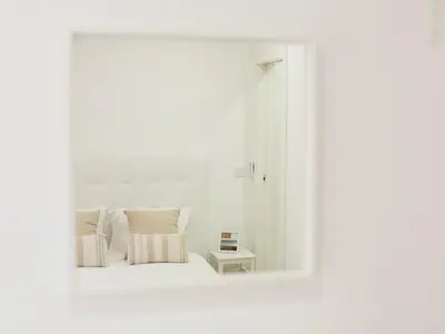 a white bedroom with a bed and a mirror at OPORTO GUEST Amparo Dollhouse in Porto