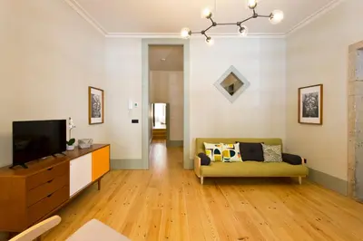 a living room with a couch and a tv at Trait House in Porto
