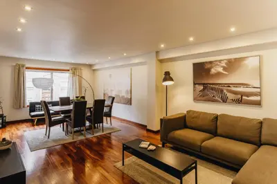 a living room with a couch and a table at Premium Apartment with Private Terrace & Garage in Porto