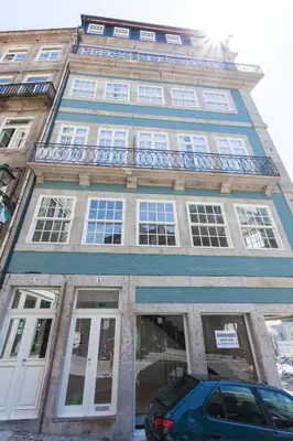 a building with a car parked in front of it at YOUROPO - City Center Ribeira Porto in Porto