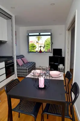 a living room with a black table and chairs at Porto Smart Apartments - Downtown in Porto
