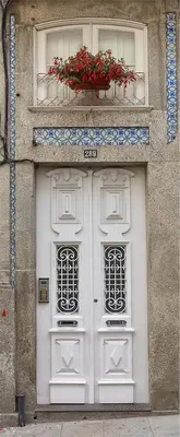 a building with a white door with a window at PortoSense Almada in Porto