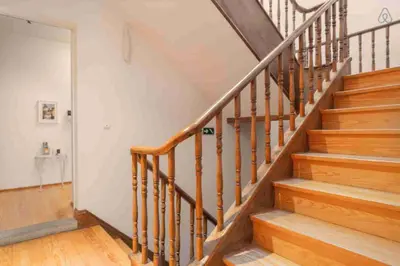 a staircase with wooden railings in a home at Flowerstreet 54 in Porto