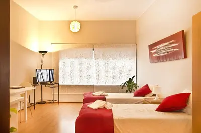 a hotel room with two beds and a window at VRS - Porto Centre Trindade Studio in Porto