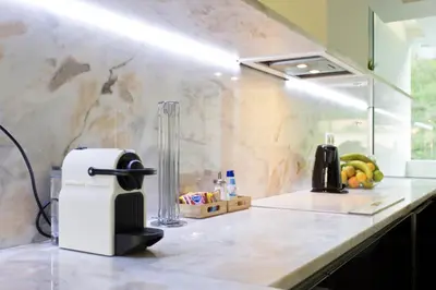 a kitchen with black cabinets and a counter top at HS Cais Cavaco in Vila Nova de Gaia