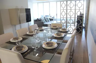 a dining room with a glass table and chairs at HS Cais Cavaco in Vila Nova de Gaia