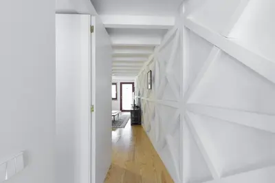 a hallway of a house with white walls and wooden floors at VIVA Caldeireiros Porto Old Town in Porto