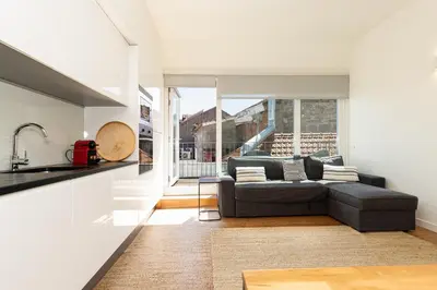 a balcony with a couch and chairs and a table at Galerias Nightlife Fashion Flats in Porto