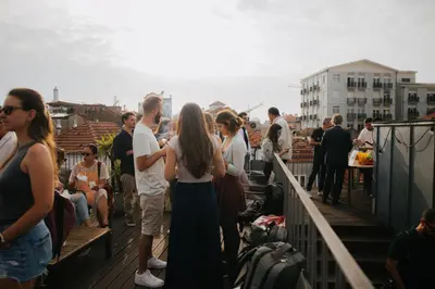 a group of people standing on a deck at Galerias Nightlife Fashion Flats in Porto