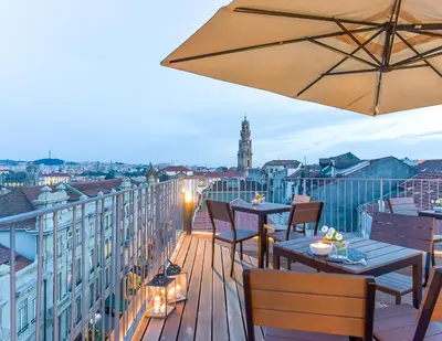 a woman looking out from a balcony of a building at Galerias Nightlife Fashion Flats in Porto