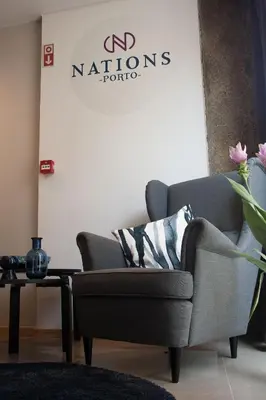 a living room with a chair and a table at Nations Porto - Studios & Suites in Porto