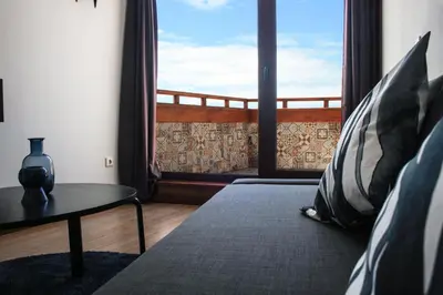 a room with a bed and a large window at Nations Porto - Studios & Suites in Porto