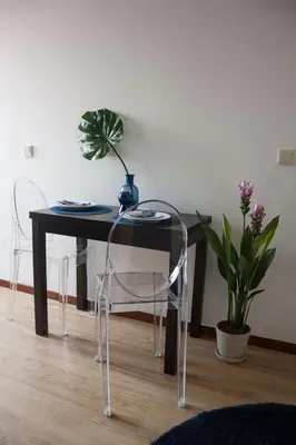 a table with chairs and a vase on top of it at Nations Porto - Studios & Suites in Porto