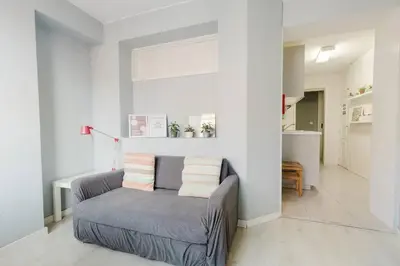 a living room with a couch with pillows on it at Lima House in Porto