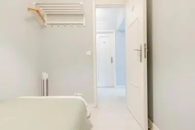 a white bathroom with a sink and a mirror at Lima House in Porto