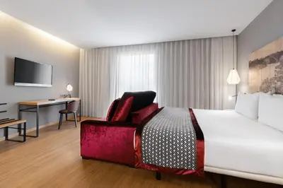 a hotel room with a large bed and a desk at Eurostars Porto Centro in Porto