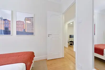 a bedroom with a door leading into a room with a bed at Sleep in Centre in Porto