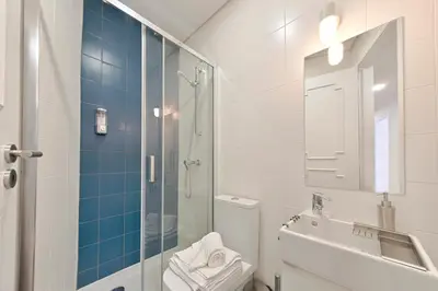 a bathroom with a shower and a toilet and a sink at Sleep in Centre in Porto