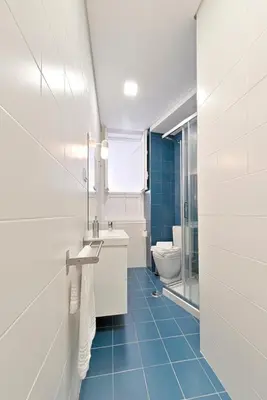 a white bathroom with a sink and a toilet at Sleep in Centre in Porto