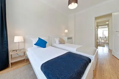 a bedroom with two beds with blue pillows at Sleep in Centre Downtown in Porto