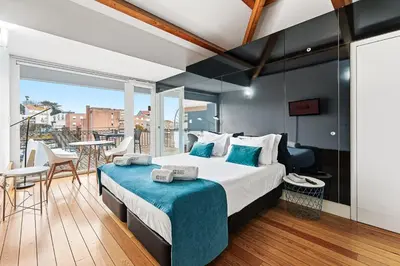 a bedroom with a large bed and a balcony at GuestReady - Cosy studio in the heart of Porto in Porto