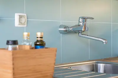 a kitchen sink with a faucet next to a counter at GuestReady - Cosy studio in the heart of Porto in Porto