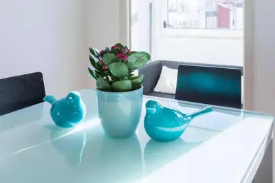 a table with a blue vase with a plant on it at Apartment Cozy 4YOU in Porto