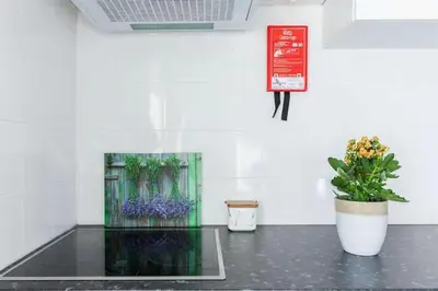 a room with two potted plants and a sign on the wall at Apartment Cozy 4YOU in Porto