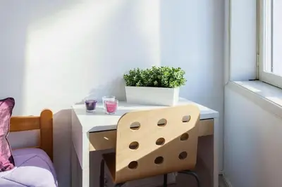 a table with a potted plant and a chair at Apartment Cozy 4YOU in Porto