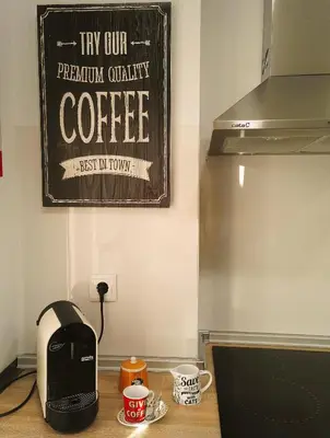 a kitchen counter with a coffee maker and coffee cups at Always Porto in Vila Nova de Gaia