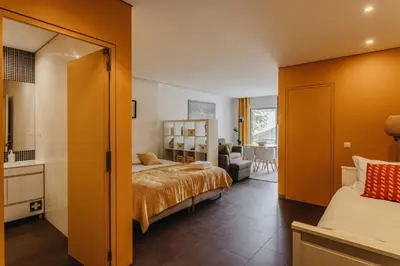a bedroom with a bed and a living room at Budget-Friendly Studio with Balcony in Rosario in Porto