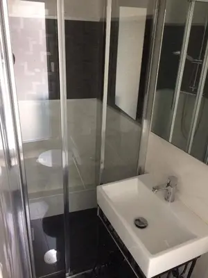 a bathroom with a white sink and a shower at The Blue and White Porto House in Porto