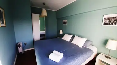 a blue bedroom with a bed with two pillows at Porto Downtown Main Str (S.Catarina) + Free Park in Porto