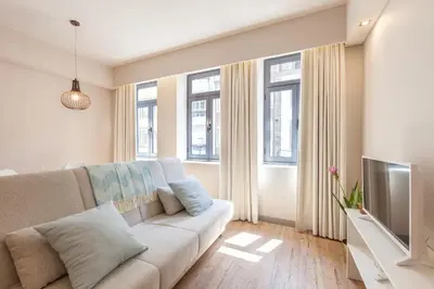 a living room with a couch and a tv at Sendme2Portugal: Santa Catarina in Porto