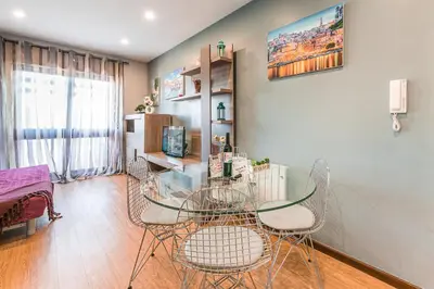 a dining room with a glass table and chairs at GuestReady - Sound of Nature - T1 Boavista in Porto