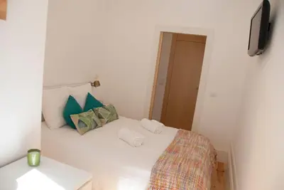 a bedroom with a bed with two towels on it at OportoView Alegria Apartment in Porto